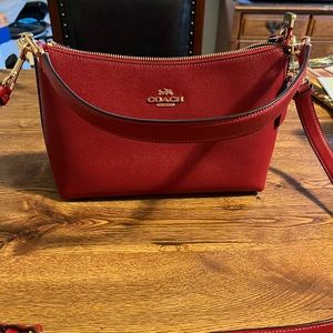 Coach purse. Red. Used once. 9 inches long by 5 3/4 high.